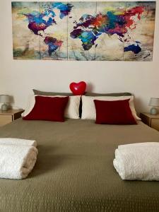 a bedroom with a bed with a painting on the wall at Bilocale degli Innamorati in Terni +55 photos