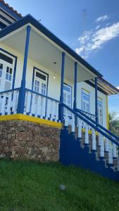 ein blau-weißes Haus mit einem Balkon in der Unterkunft Pousada Usina Paraíso in Astolfo Dutra