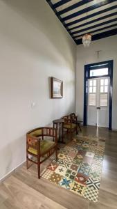 a room with two benches and a rug on the floor at Pousada Usina Paraíso in Astolfo Dutra