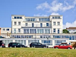 a large white building with cars parked in front of it at 5 Devon Beach Court in Woolacombe