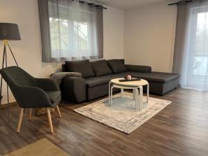 a living room with a couch and a table at Golden Apartment Schwabach in Schwabach