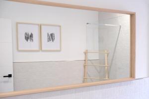 a bathroom with two pictures of shoes on the wall at AOVE Suite in Jaén