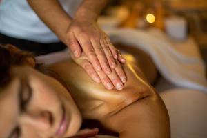 a woman getting a massage from a therapist at Spa Village at Hamat Gader - adults only in Hamat Gader