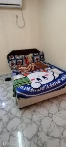 a bed sitting in a room with aamed at Wummies place in Abu Dhabi
