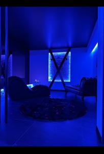 a blue room with a bed and a window at Loveroom Metz Spa Privatif in Metz