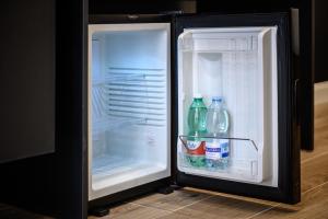 an open refrigerator with soda and water in it at Interno Barocco in Naples