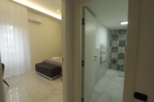 a bathroom with a glass door leading to a bedroom at Tommy's Apartment in Pompei +67 photos
