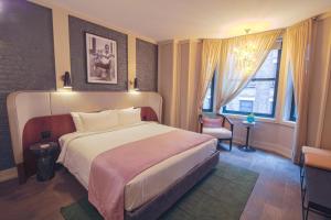 a bedroom with a large bed and a window at The Evelyn NoMad in New York