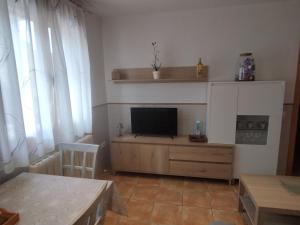 a living room with a television on a wooden entertainment center at Apartamento Torre Sancho in Valderrobres