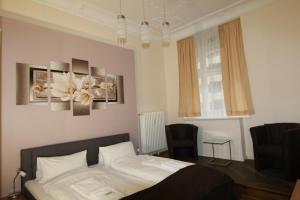 Postel nebo postele na pokoji v ubytování Hotel Elegia am Kurfürstendamm
