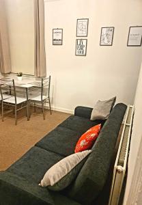 a bedroom with a bed and a table and a dining room at Rooms Anfield- 5 mins from LFC in Liverpool