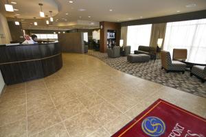 a lobby of a hotel with a woman sitting at a counter at MainStay Suites Hobbs in Hobbs