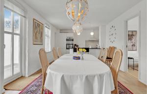 a white dining room with a white table and chairs at 3 Bedroom Beautiful Home In Bryrup in Bryrup
