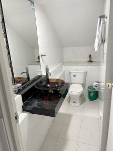 a bathroom with a sink and a toilet at Casa Hotel Quinta Real in Bogotá