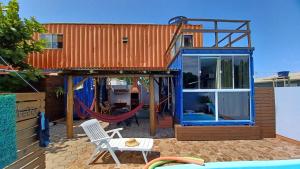 a house with a pool and a swing at Hospedagem Tribos Livres in Torres