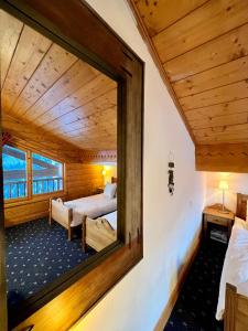 a mirror in a room with a bedroom at Chalet Rocher in La Thuile Sainte-Foy-Tarentaise