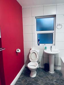 a bathroom with a toilet and a sink at 03 Bedroom Apartment-Self Check in in London