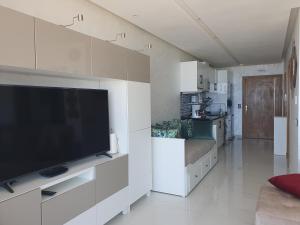 a living room with a large flat screen tv at Superbe appartement pieds dans l'eau Mehdia in Kenitra