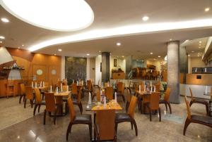 a dining room with wooden tables and chairs at El Dorado Hotel in Cuenca