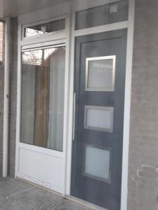 a blue door with a window on a house at Studio in Eindhoven in Eindhoven