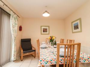 a dining room with a table and chairs at Grove Cottage in Whitby