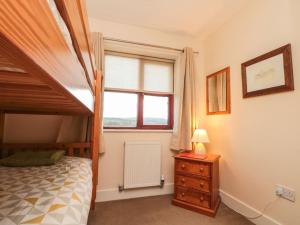 a bedroom with a bed and a window at Grove Cottage in Whitby