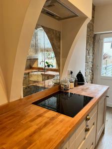 a kitchen with a wooden counter top in a room at Wellington Cottage in Ilkley