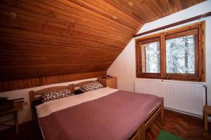 una camera da letto con un letto in una stanza di legno di Rustic Home Tara a Kaludjerske Bare