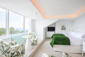 a bedroom with a bed with a green blanket at The Nici in Bournemouth