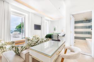 a living room with a desk and a bedroom at The Nici in Bournemouth