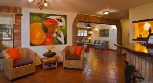 a living room with chairs and a painting on the wall at Hostal San Francisco in San Cristóbal