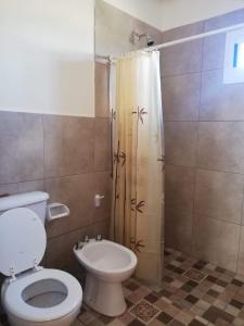 a bathroom with a toilet and a shower at Cabañas mi Terruño in San Rafael