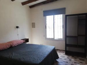 a bedroom with a bed and a large window at Cabañas mi Terruño in San Rafael