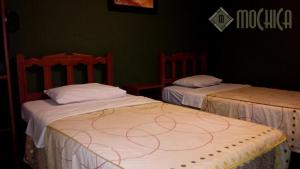 Letto o letti in una camera di Hostal Residencial Mochica