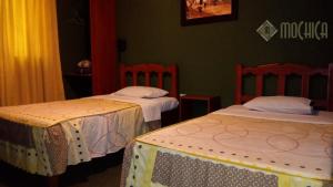 Letto o letti in una camera di Hostal Residencial Mochica