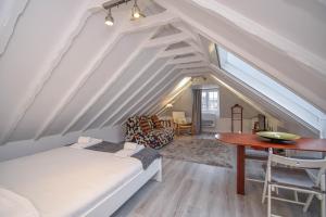 a attic bedroom with a bed and a desk at Bica Loft in Lisbon