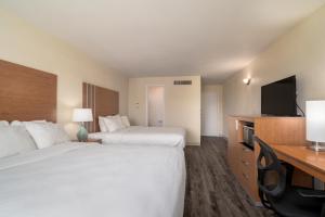 a hotel room with two beds and a flat screen tv at Nevada Flats Hotel in Colorado Springs