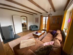 a living room with a couch and a tv at Am Kaisersteig in Zwiesel