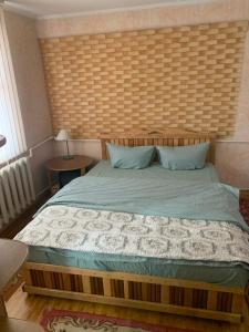 a bedroom with a large bed with a wooden headboard at Popas Regal 