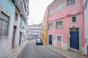 a car driving down a street in an alley at Bica Loft in Lisbon