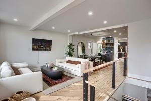 a living room with a white couch and a table at Urban Oasis Retreat With Luxury Design, Hot Tub, Fire Pit, Breathtaking Downtown & River Views in Pittsburgh