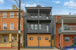 an apartment building with a balcony on the side of it at Urban Oasis Retreat With Luxury Design, Hot Tub, Fire Pit, Breathtaking Downtown & River Views in Pittsburgh