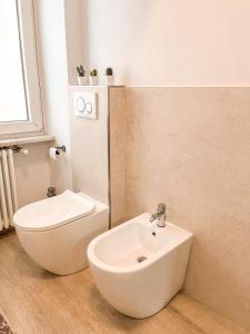 a white bathroom with a sink and a toilet at 583slm in Aosta