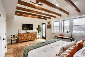 a bedroom with white walls and wooden beams at Urban Oasis Retreat With Luxury Design, Hot Tub, Fire Pit, Breathtaking Downtown & River Views in Pittsburgh