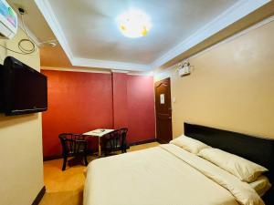 A bed or beds in a room at Drake Hotel Angeles City