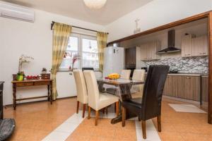 - une cuisine et une salle à manger avec une table et des chaises dans l'établissement Spacious apartments with pool, Pakoštane, à Pakoštane