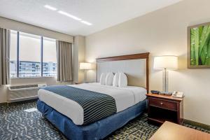 a hotel room with a large bed and a window at Best Western Cocoa Beach Hotel & Suites in Cocoa Beach