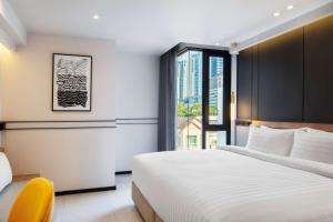 a hotel room with a bed and a window at Best Western Ratchada Hotel in Bangkok