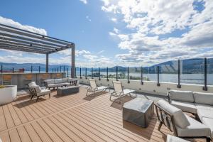 a deck on a cruise ship with chairs and tables at Brand New Luxury Downtown Near the Beach #10 in Kelowna