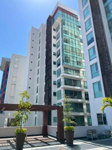 a tall building with two trees in front of it at Penthouse Minerva in Guadalajara